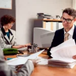 personal injury lawyer helping accident victim in office